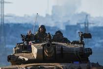 Israeli soldiers drive a tank on the border with the Gaza Strip, as seen from southern Israel, ...