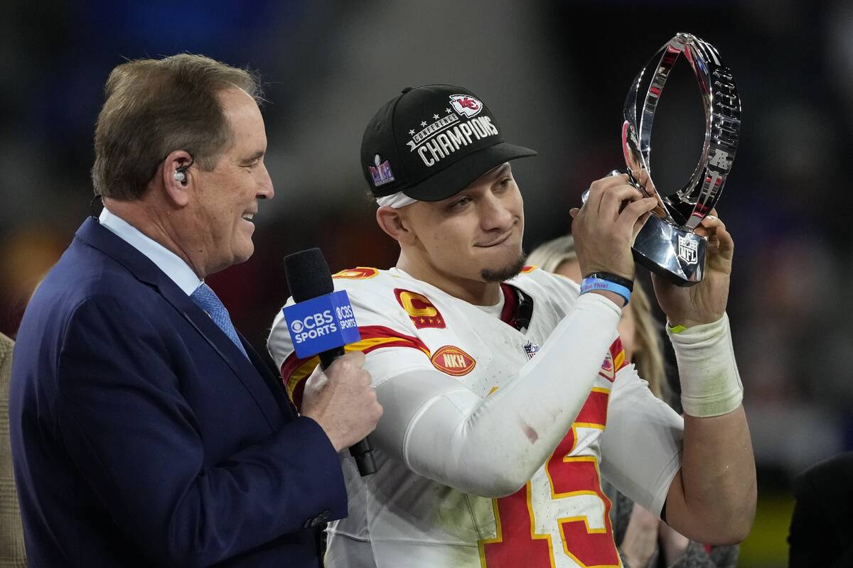 Kansas City Chiefs quarterback Patrick Mahomes (15) holds up the Lamar Hunt Trophy after the AF ...