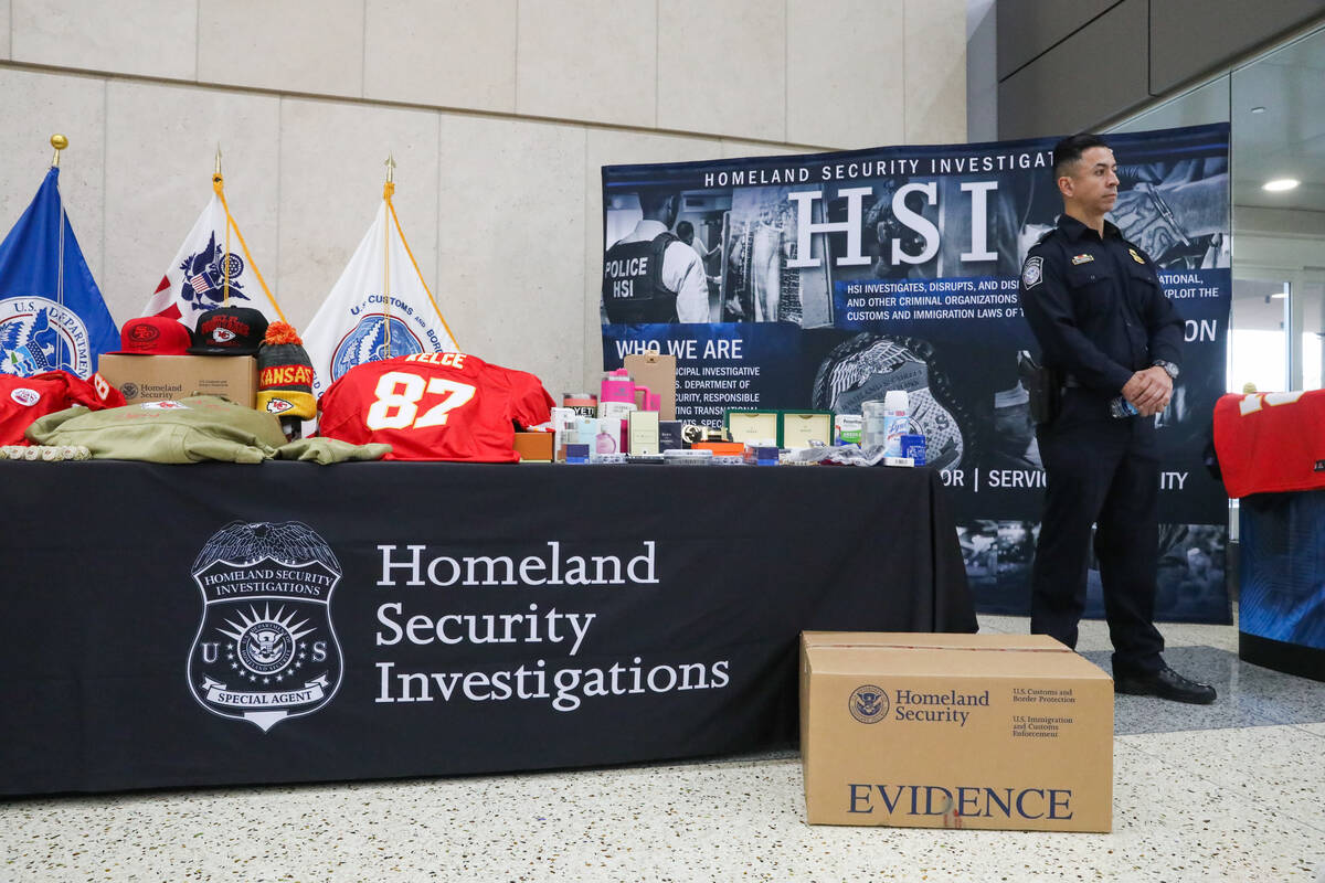Officer Villagrana stands beside a display of fake super bowl paraphernalia during a Super Bowl ...