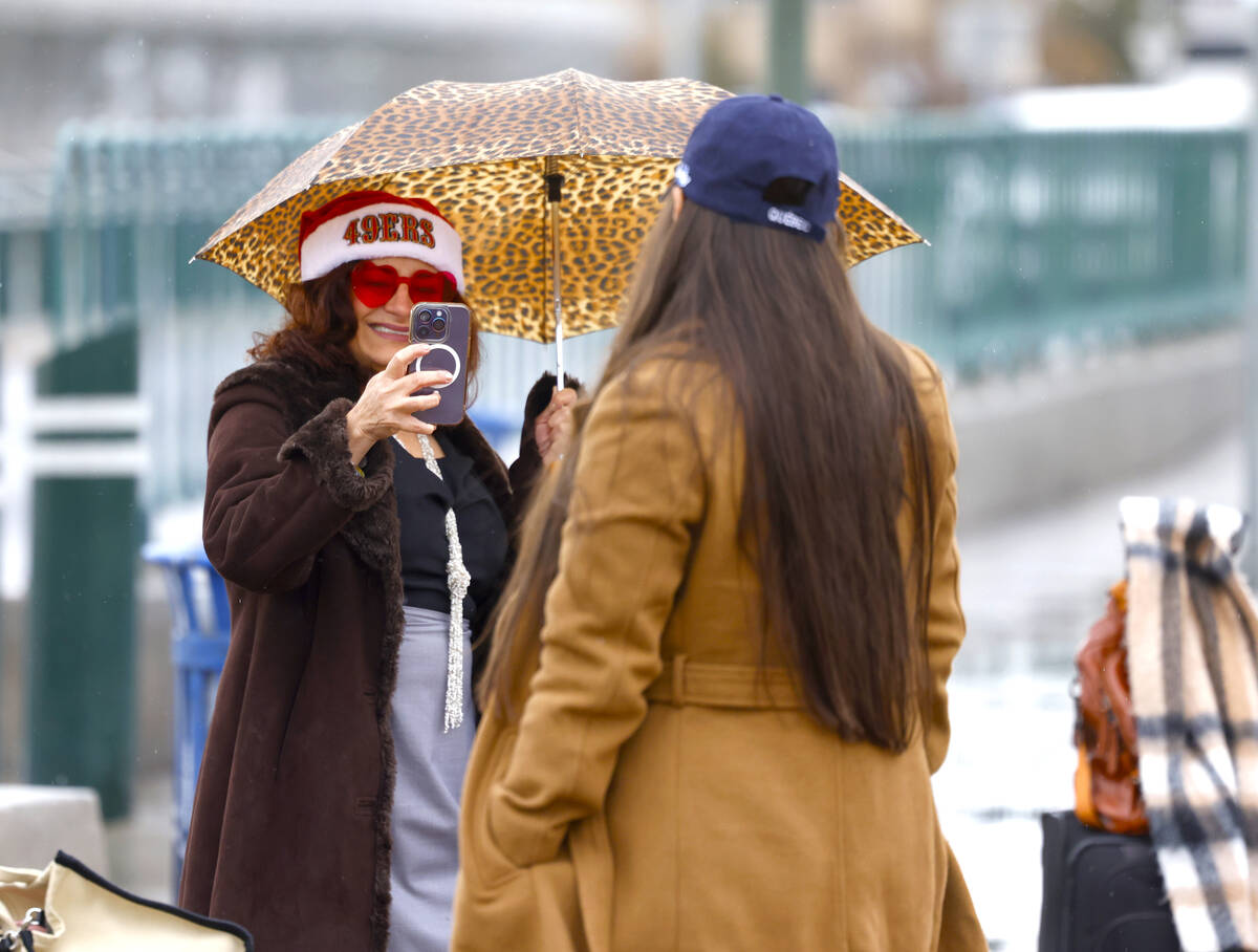 Nelly Gutierrez of San Jose, Calf., left, takes a photo of her friend Alejandro Soto near the & ...