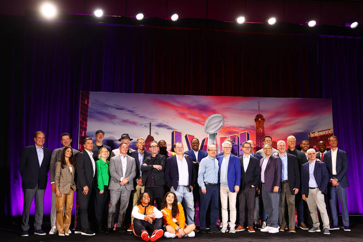 The CBS Sports broadcast team poses for a photo during a news conference at Mandalay Bay ahead ...