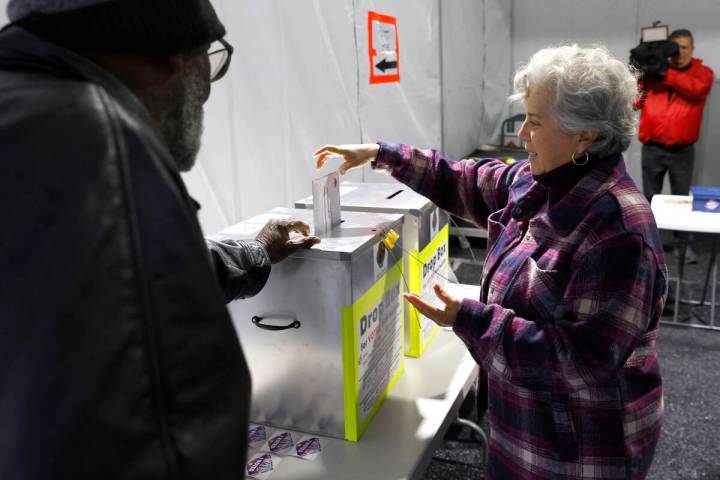 Martha Morris casts her ballot at a vote by mail dropbox during primary voting in Las Vegas Tue ...