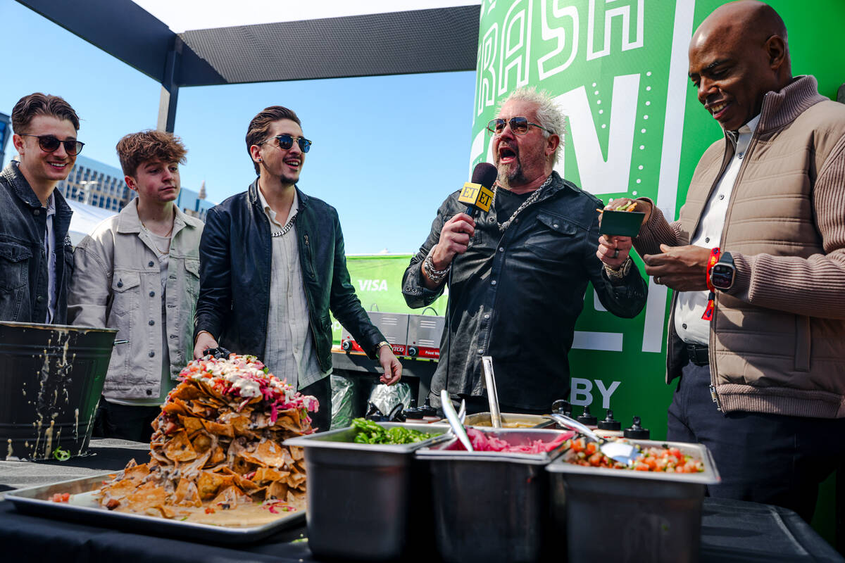 Celebrity chef Guy Fieri addresses the crowd with his nephew Jules Fieri, from left, son Ryder ...