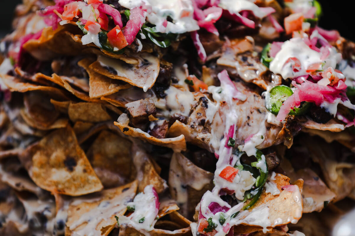 Trash can nachos at Guy’s Flavortown Tailgate party for Super Bowl LVIII at a parking lot nea ...