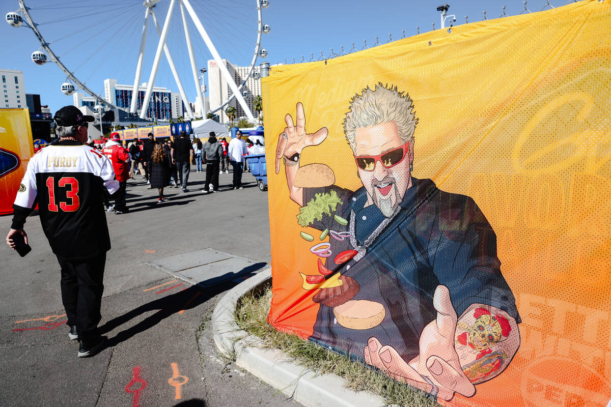 Crowds eat and order food at Guy’s Flavortown Tailgate party for Super Bowl LVIII at a p ...