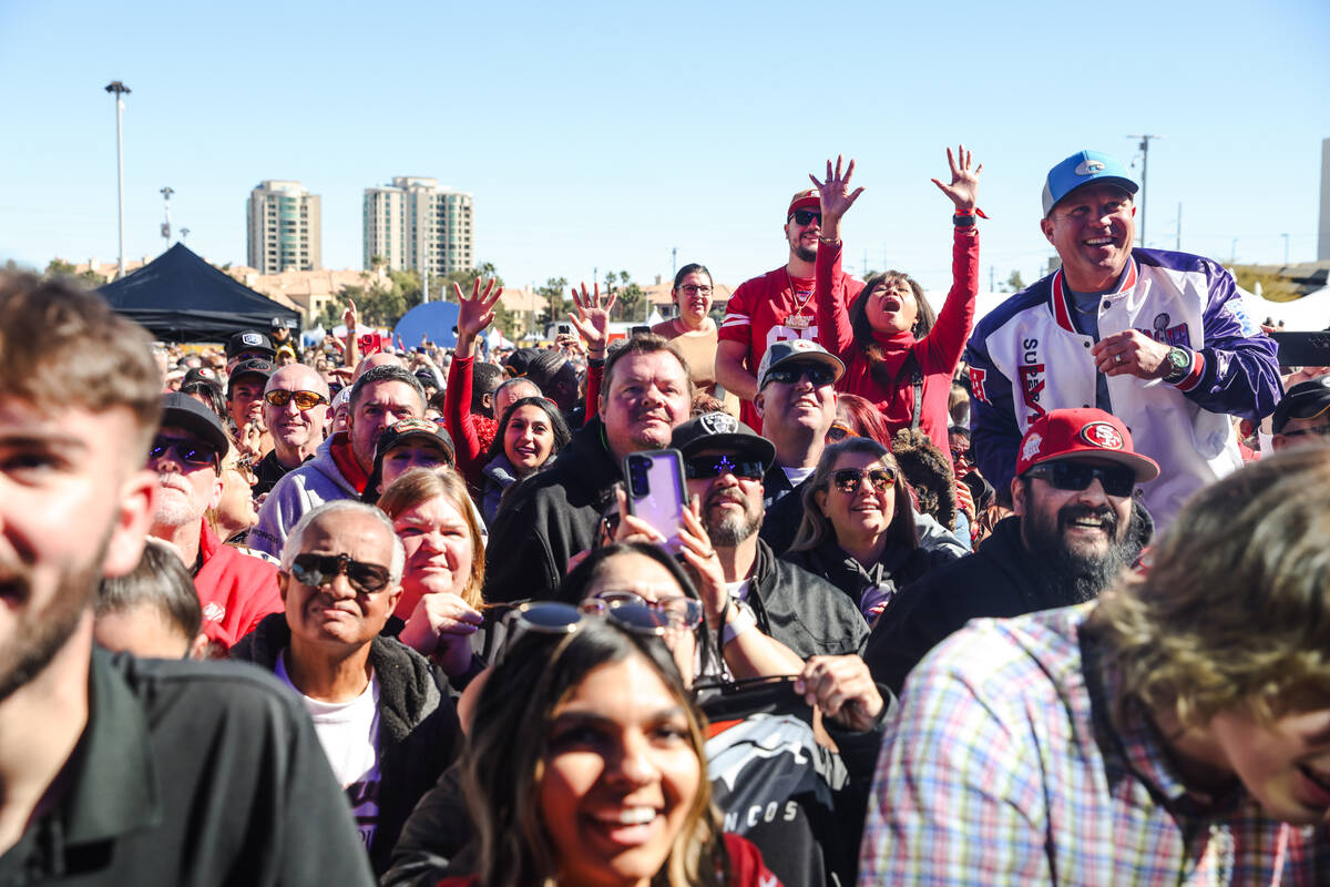 The audience at Guy’s Flavortown Tailgate party for Super Bowl LVIII at a parking lot ne ...
