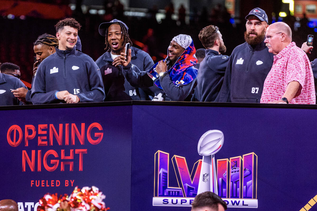 Kansas City Chiefs players and coaches stand before the crowd on the field during the Super Bow ...