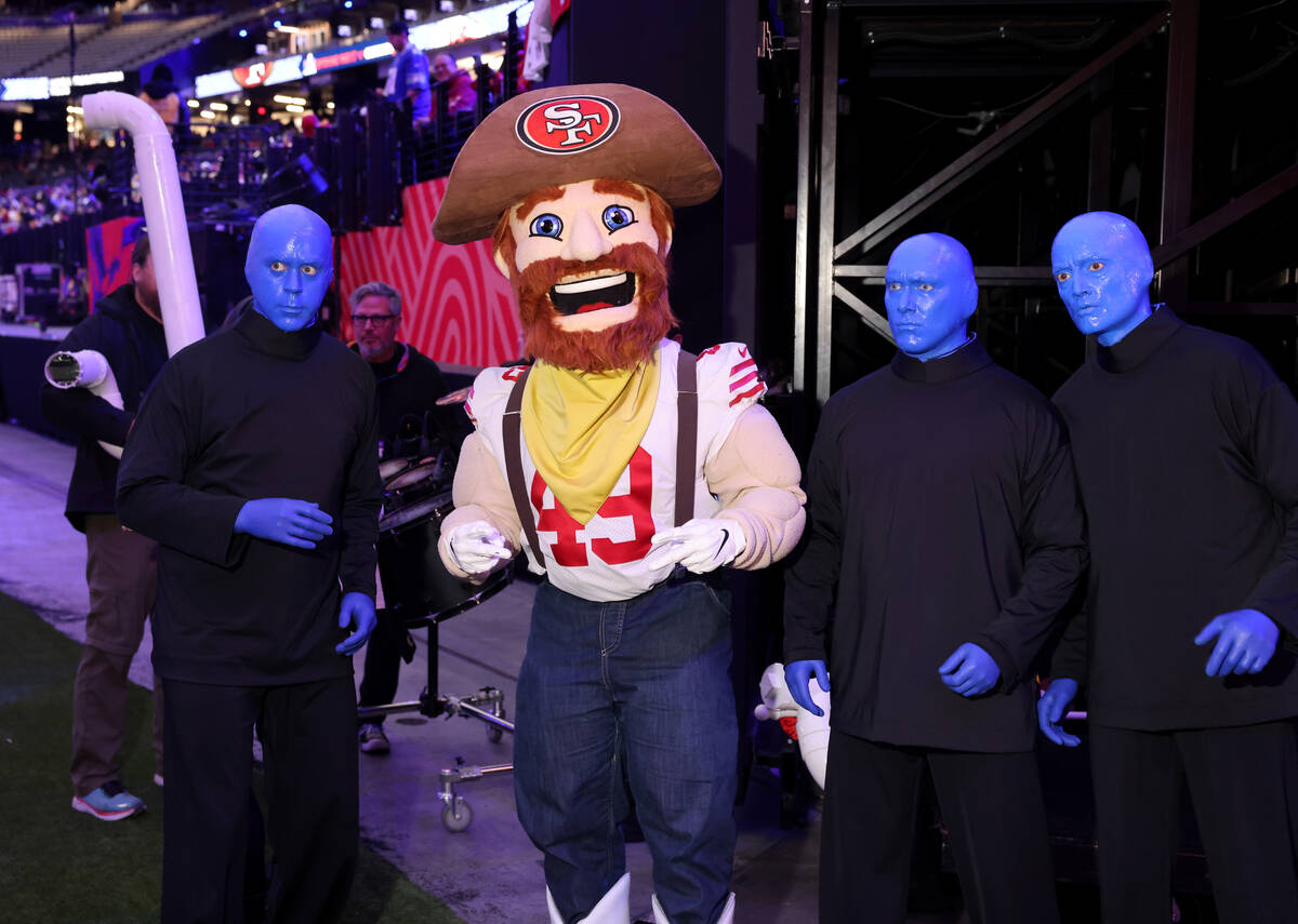San Francisco 49ers mascot Sourdough Sam mingles with the Blue Man Group during Super Bowl Open ...