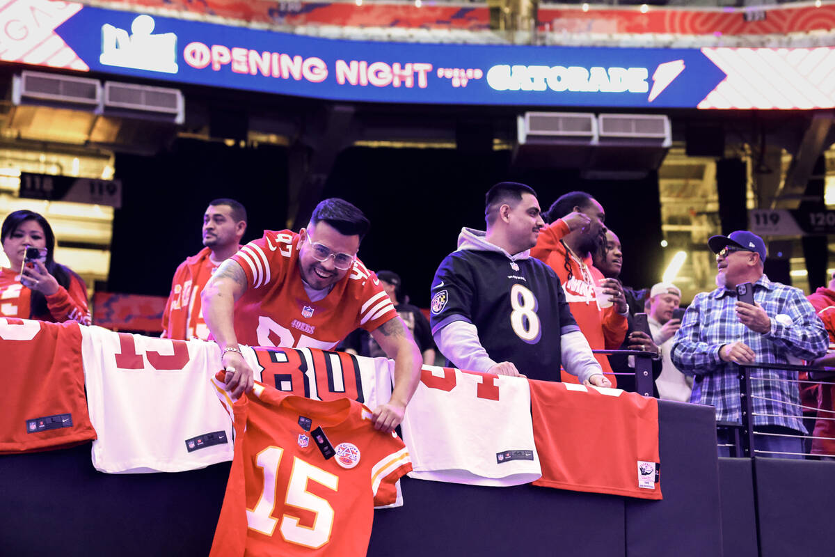 San Francisco 49ers fans snag T-shirts during Super Bowl Opening Night festivities at Allegiant ...