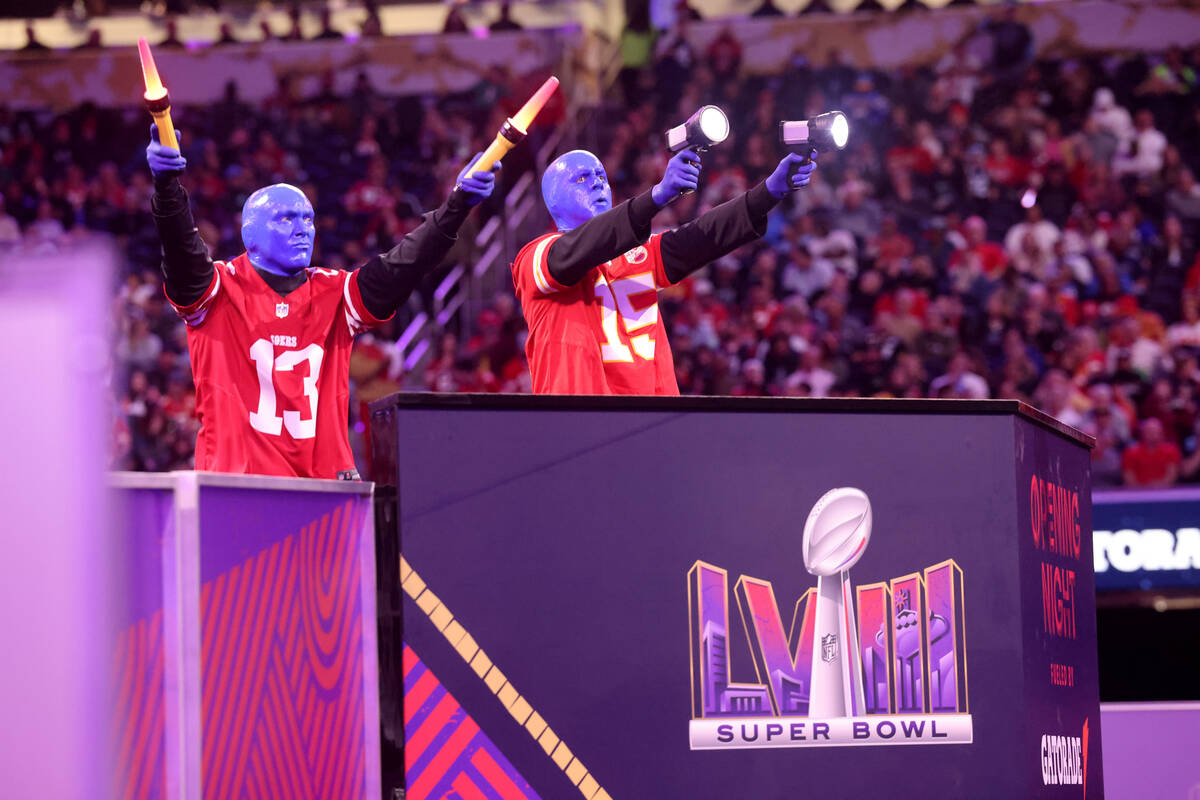 Members of the Blue Man Group entertain the crowd during Super Bowl Opening Night festivities a ...