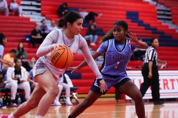 Liberty’s Samantha Chesnut (5) drives past Centennial’s Azaia Tatum (1) during a ...