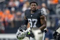 Raiders defensive end Janarius Robinson (97) stretches before an NFL game against the Denver Br ...