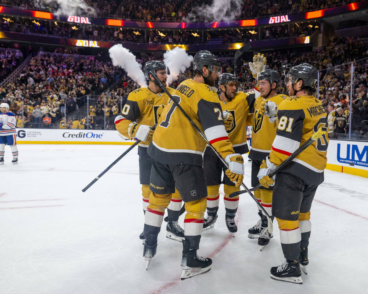 Golden Knights center Nicolas Roy (10) and teammates celebrate his goal against Edmonton Oilers ...
