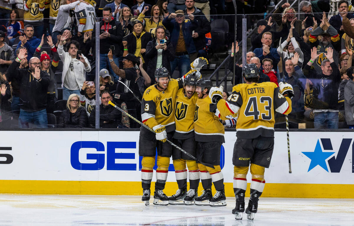 Golden Knights center Chandler Stephenson (20) has a goal celebrated with teammates over the Ed ...