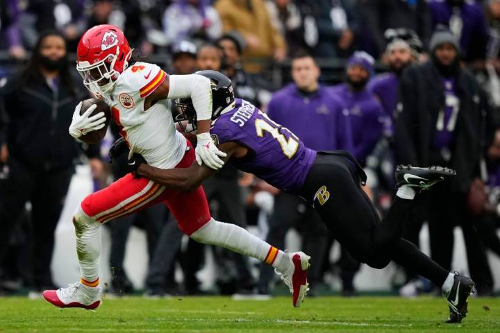 Kansas City Chiefs wide receiver Rashee Rice (4) is tackled by Baltimore Ravens cornerback Bran ...