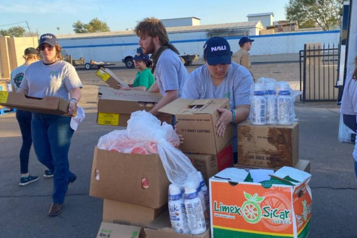 Food Recovery Network volunteers sort leftover food from the 2023 Super Bowl in Glendale, Ariz. ...