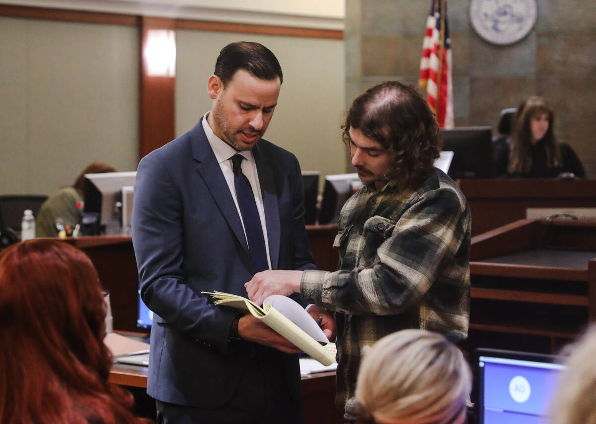 Attorney Eric Pepperman speaks with plaintiff Myles Hunwardsen following a verdict in a lawsuit ...