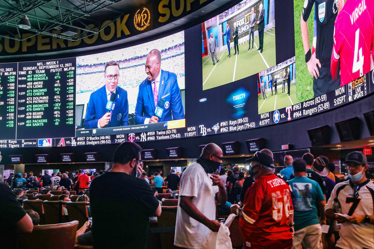 A packed house watches the screens at the Sports Book at Westgate in Las Vegas, Sunday, Sept. 1 ...