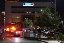 Police gather outside University Medical Center after a Metro officer was injured in a shooting ...