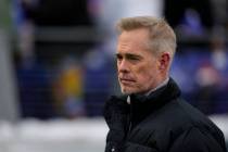 ESPN broadcaster Joe Buck walks the field before an NFL football AFC divisional playoff game be ...