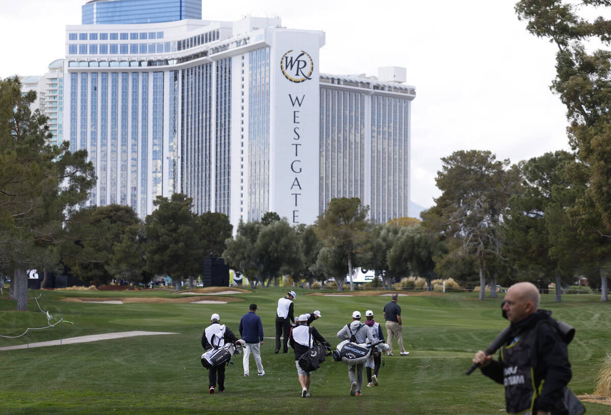 Players walk toward the 18th green during LIV Golf Las Vegas Pro-Am tournament at Las Vegas Cou ...