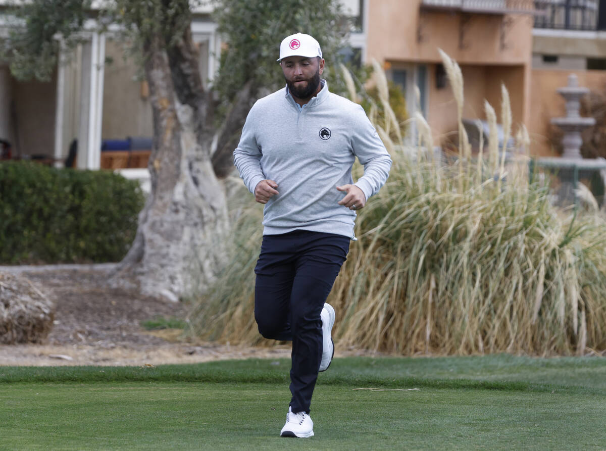 Jon Rahm runs to catch up with other players after giving an interview during LIV Golf Las Vega ...