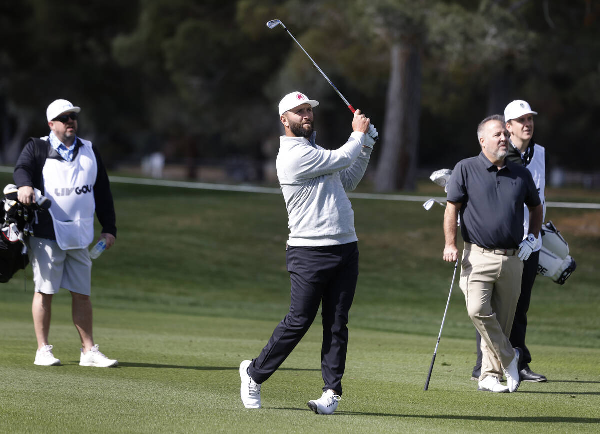 Jon Rahm watches his tee shot on the 18th hole during LIV Golf Las Vegas Pro-Am tournament at L ...