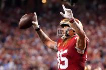 San Francisco 49ers tight end George Kittle celebrates after running back Elijah Mitchell score ...