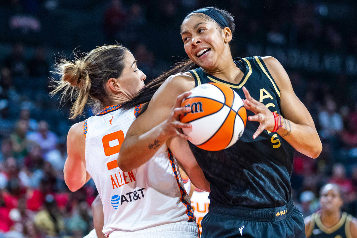 Las Vegas Aces forward Candace Parker (3) comes around the back of Connecticut Sun guard Rebecc ...