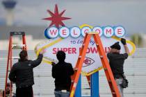 Workers prepare a welcome to Las Vegas sign in preparation of team arrivals ahead of the NFL Su ...