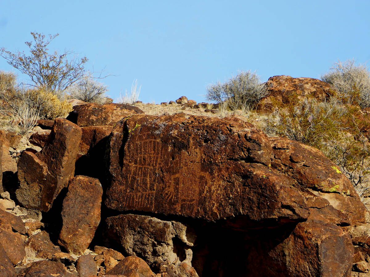 A petroglyph of Pahranagat Man can be seen high on a cliff through binoculars from across U.S.H ...