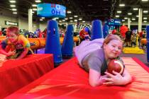 Gwen Clawson 9, of Puyallup, WA., dives onto a mat after navigating tackle dummies on a small o ...