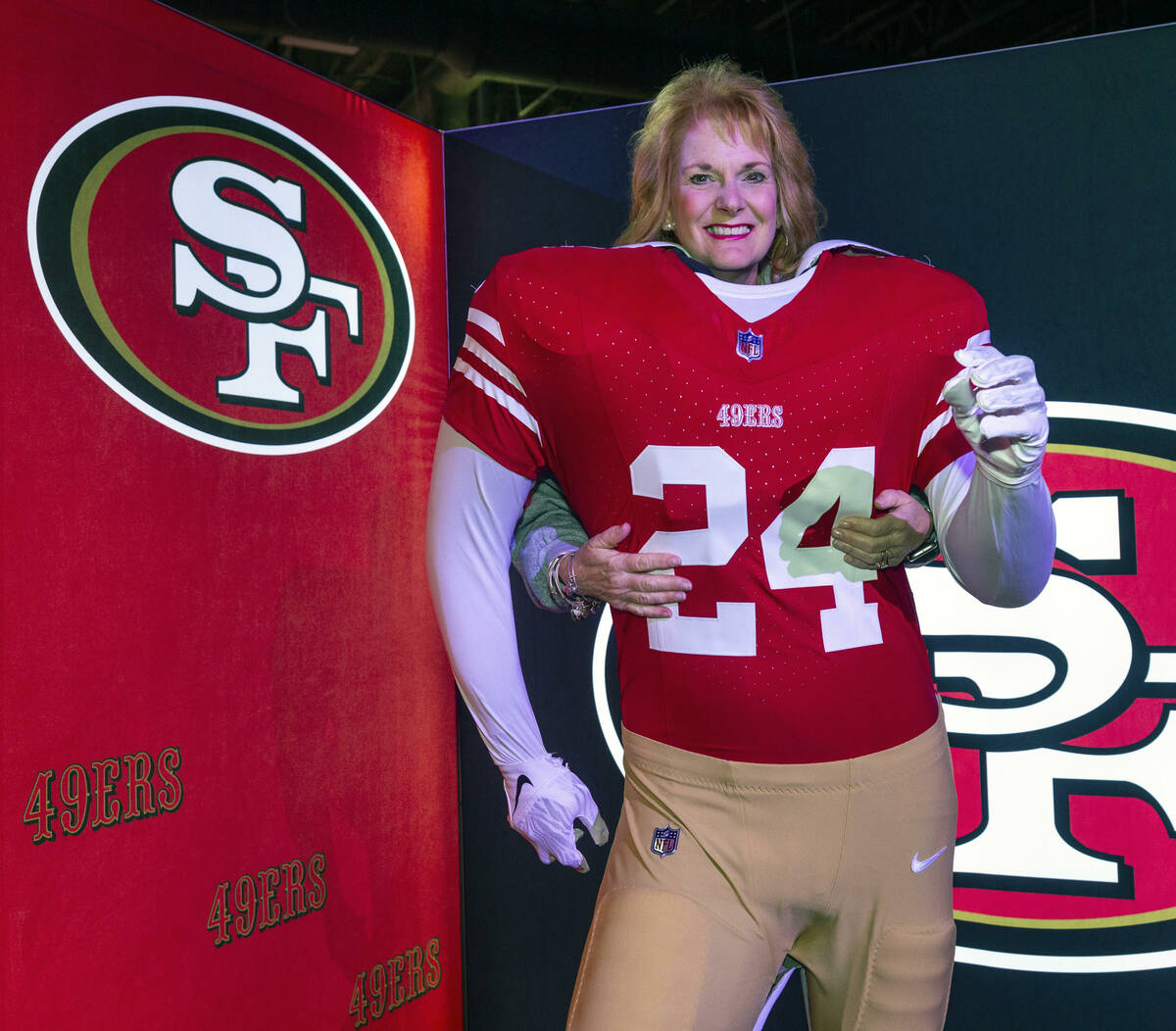 Lynda Scullin of Las Vegas stands behind a San Francisco 49ers player body during the Super Bow ...