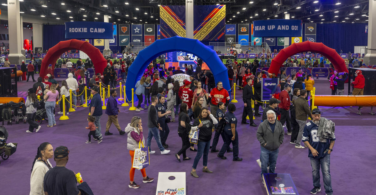 Fans walk about the Super Bowl Experience at the Mandalay Bay Convention Center on Wednesday, F ...