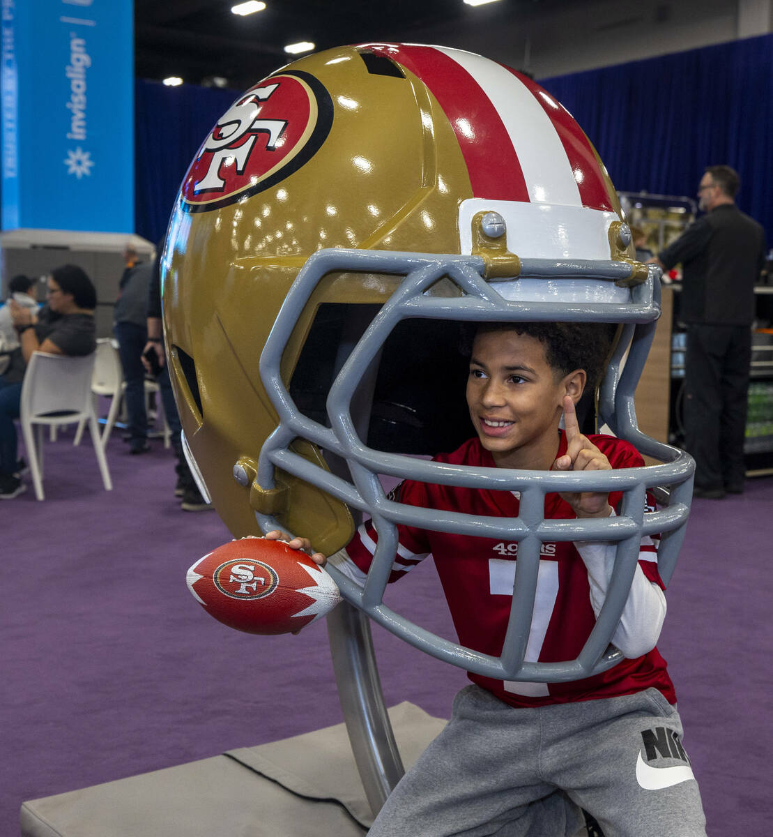 Maxwell Mikell, 11, of Las Vegas, poses within a giant San Francisco 49ers helmet during the Su ...