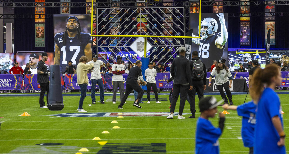 Fans attend a skills training session at the Super Bowl Experience at the Mandalay Bay Conventi ...
