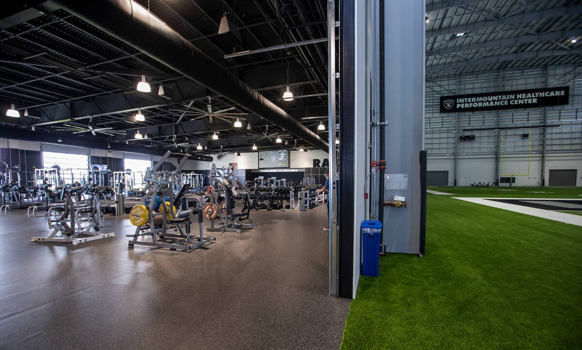 A large weight room opens to the indoor practice field within the Intermountain Healthcare Perf ...