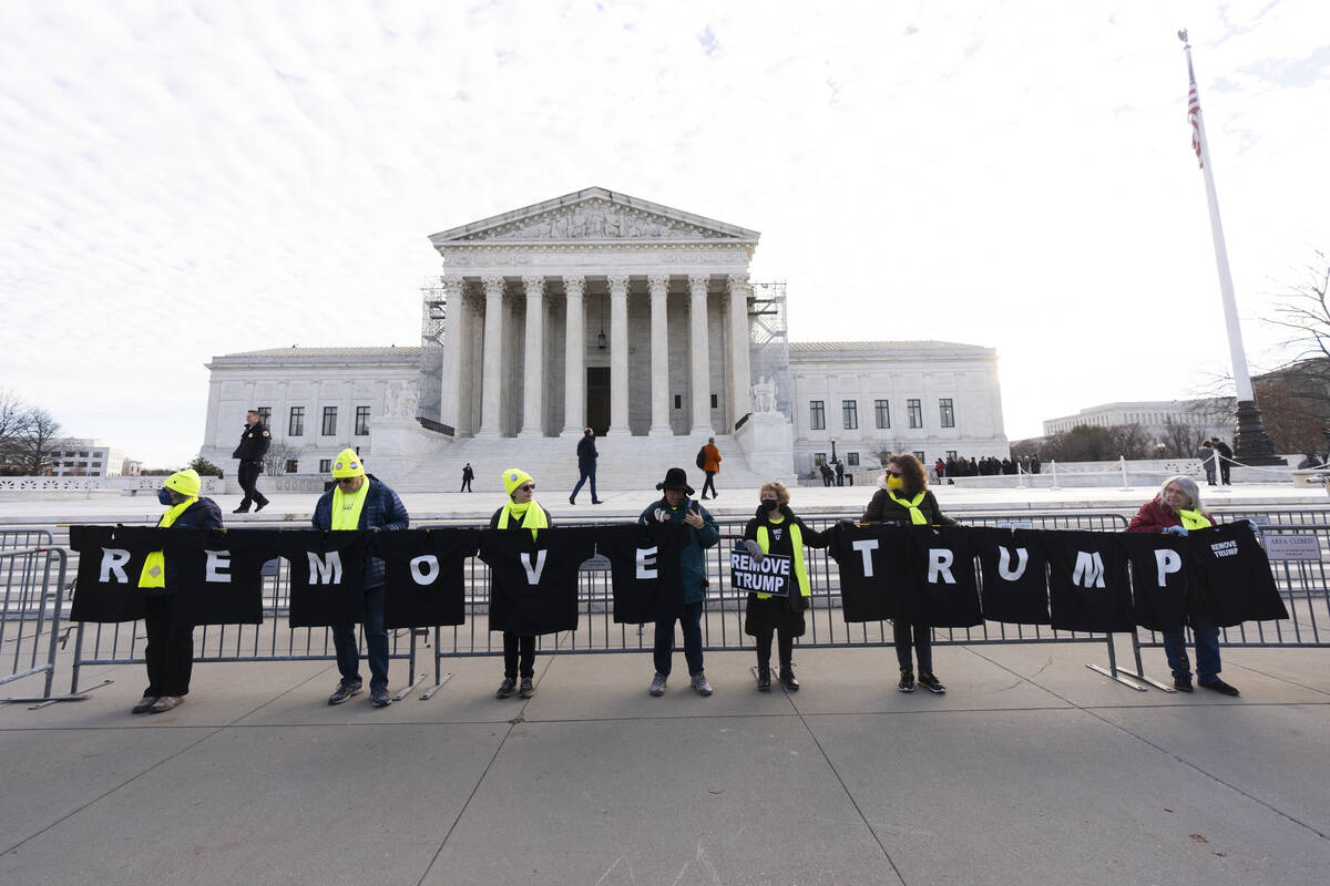 Protesters hold their banners in front of the U.S. Supreme Court, Thursday, Feb. 8, 2024, in Wa ...