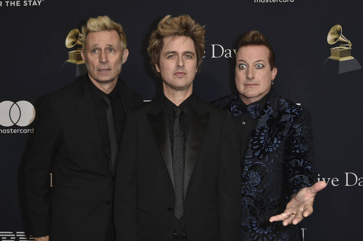 Mike Dirnt, from left, Billie Joe Armstrong, and Tre Cool of Green Day arrive at the Pre-Grammy ...