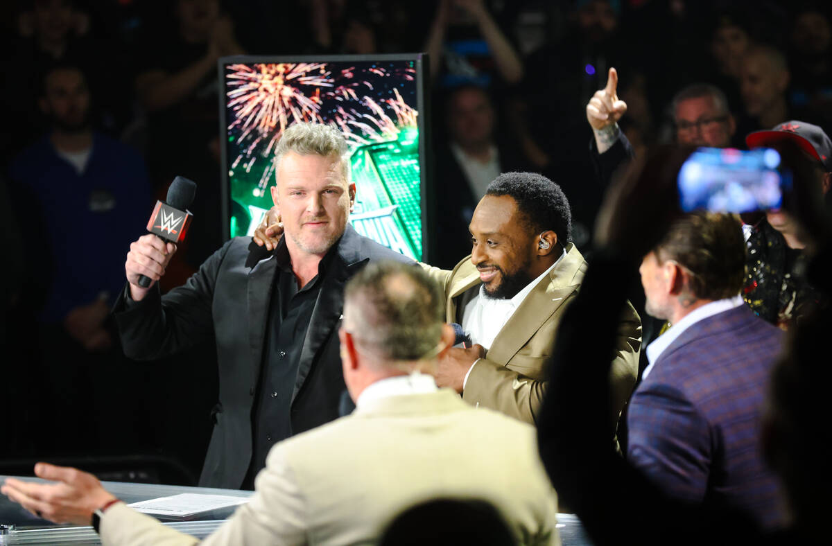 Pro wrestler Pat McAfee, left, and pro wrestler Big E embrace as they host a press conference f ...