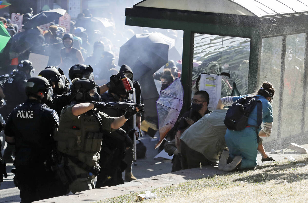 FILE - A nurse, right, who was providing volunteer medical care to protesters, comes to the aid ...