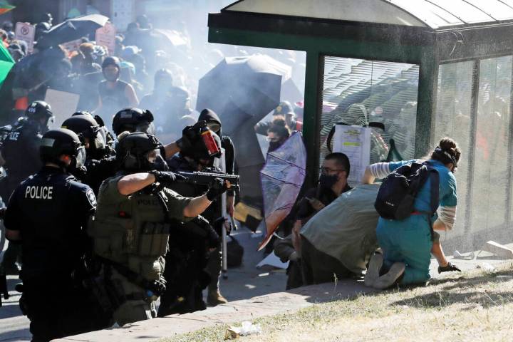 FILE - A nurse, right, who was providing volunteer medical care to protesters, comes to the aid ...