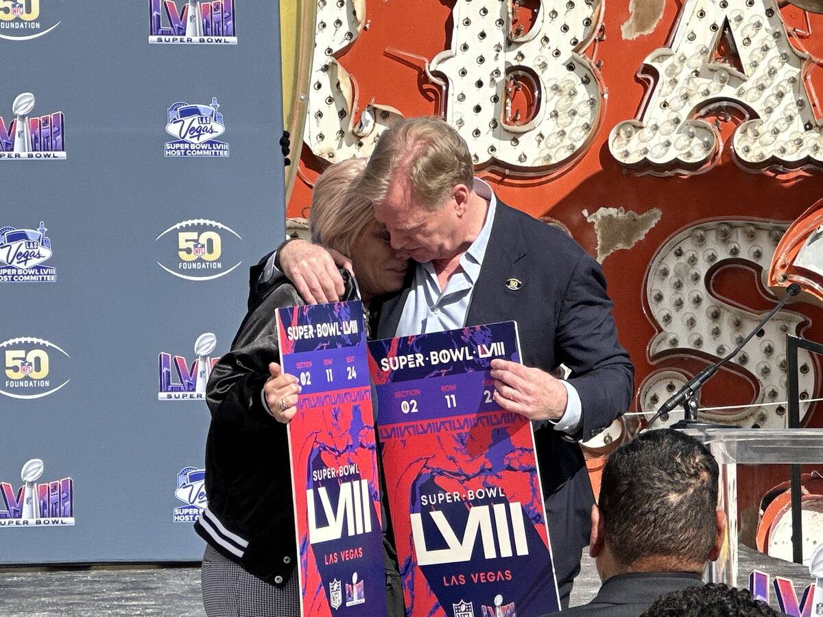 NFL Commissioner Roger Goodell (right) hugs Courtney Kaplan after surprising her with tickets t ...