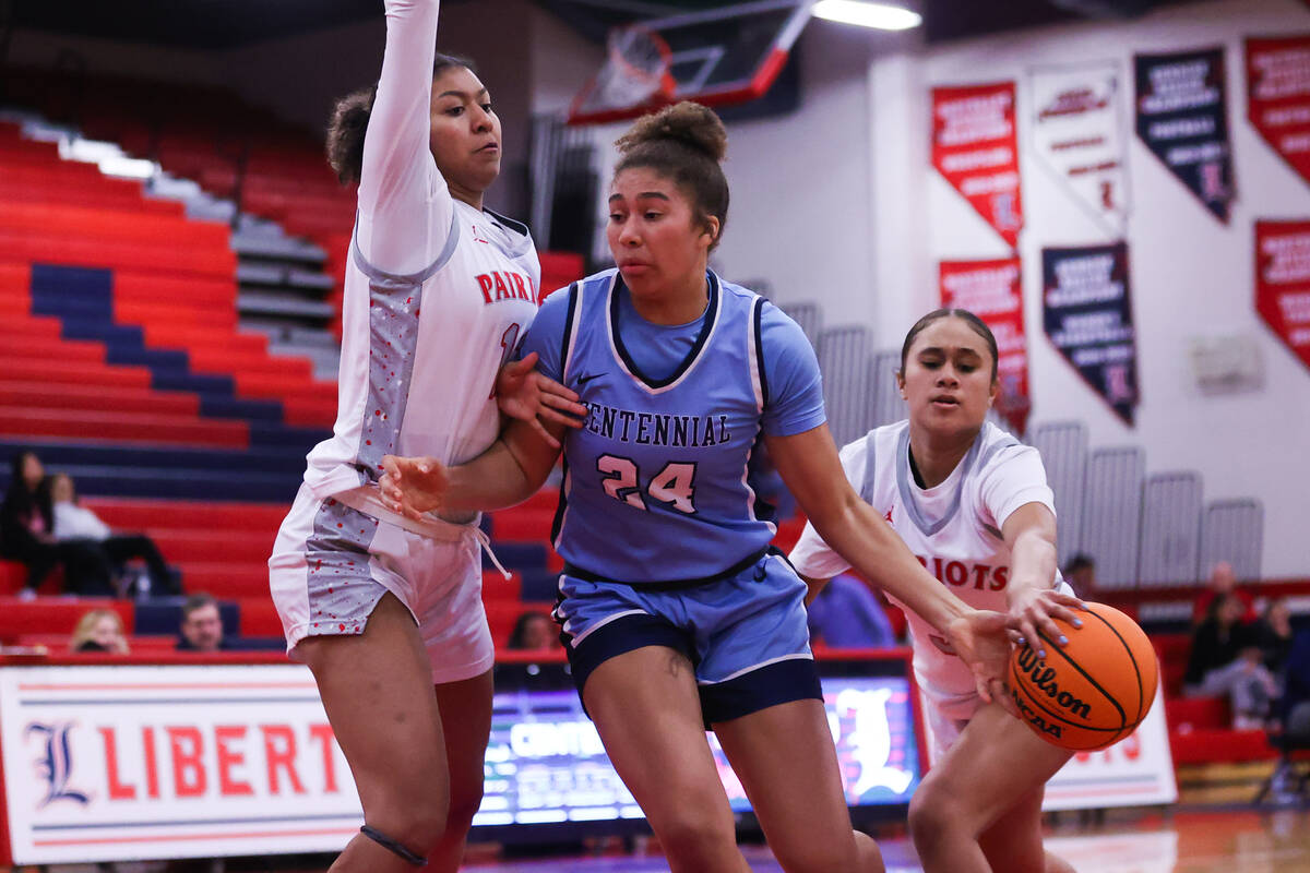 Centennial’s Nation Williams (24) is guarded by Liberty’s Neviah Nick (1) and Alo ...