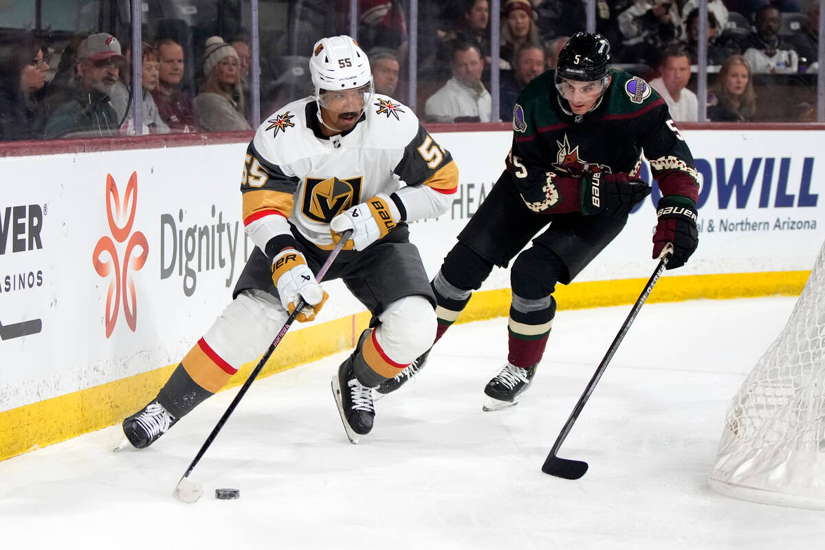 Vegas Golden Knights right wing Keegan Kolesar shields the puck from Arizona Coyotes defenseman ...