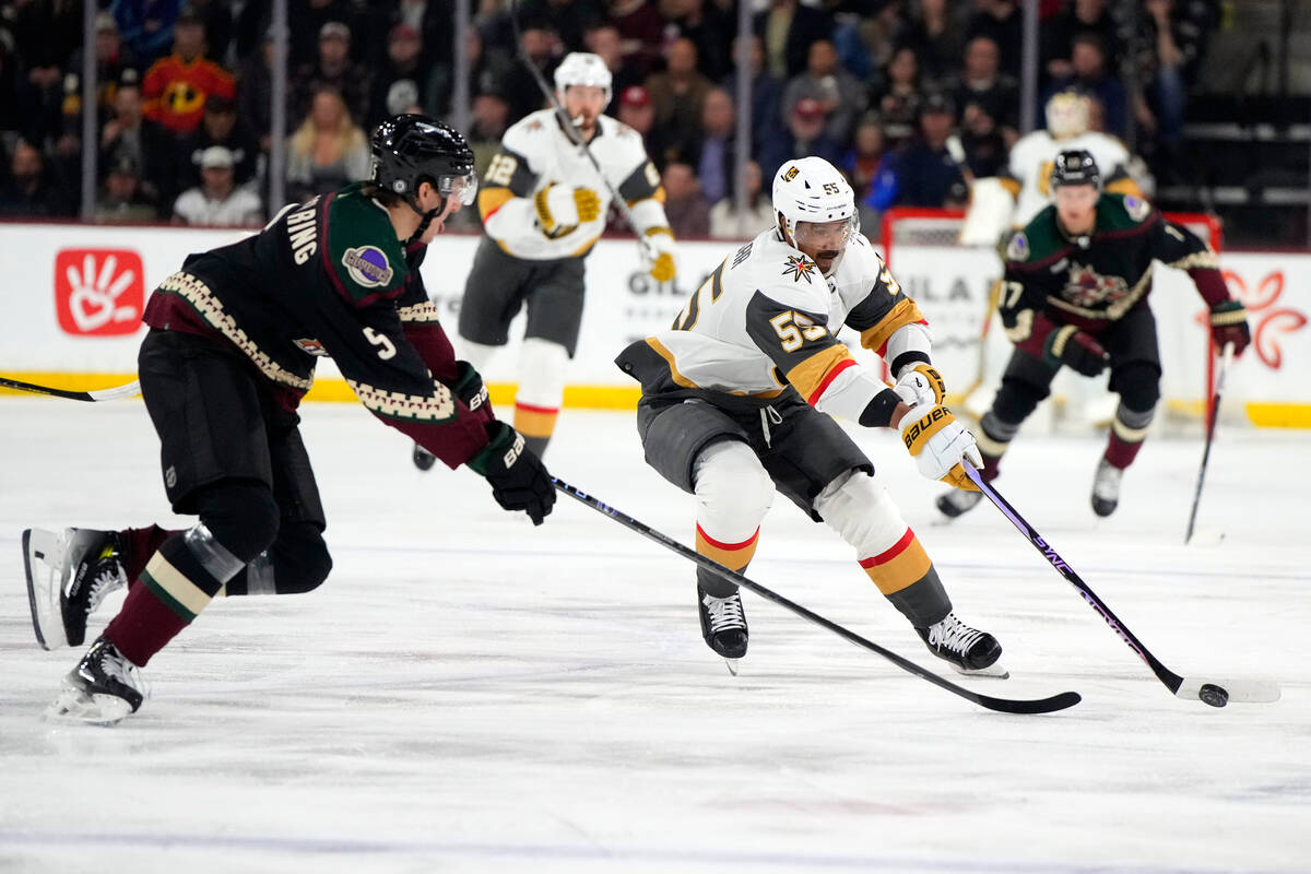 Vegas Golden Knights right wing Keegan Kolesar shields the puck from Arizona Coyotes defenseman ...