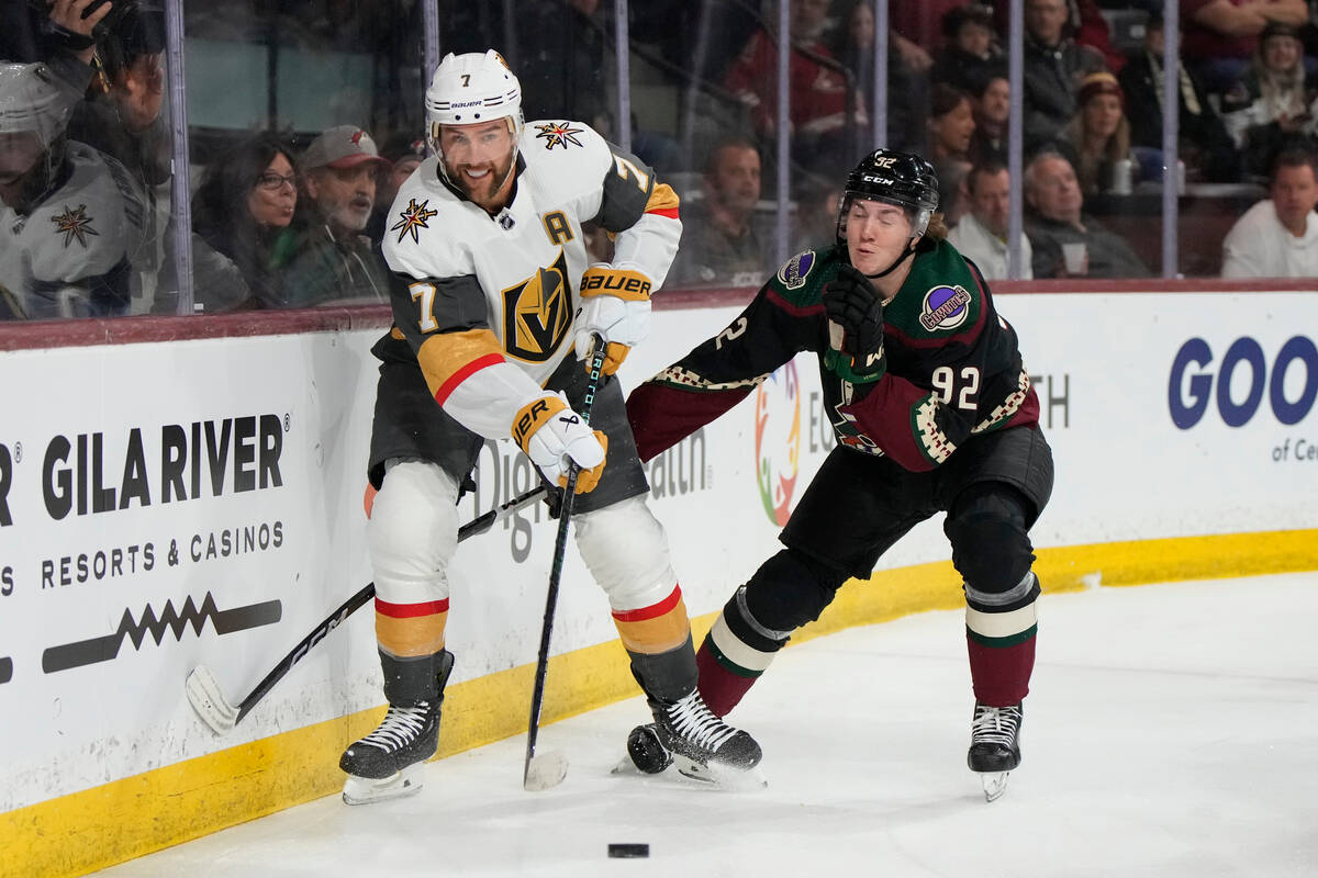 Vegas Golden Knights defenseman Alex Pietrangelo (7) shields the puck from Arizona Coyotes cent ...