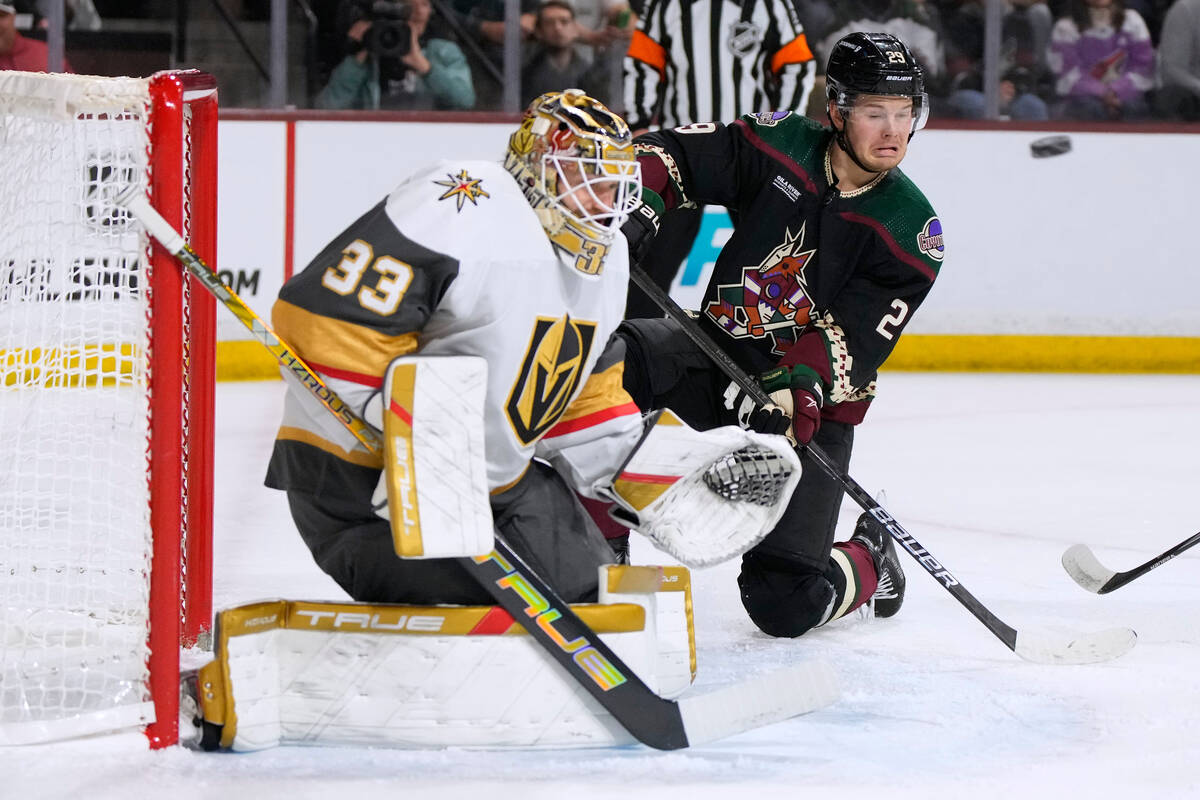 Arizona Coyotes center Barrett Hayton tries to score on Vegas Golden Knights goaltender Adin Hi ...