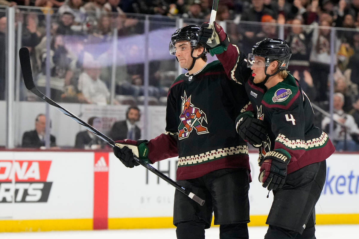 Arizona Coyotes defensemen Michael Kesselring and Juuso Valimaki (4) celebrate Jason Zucker's g ...
