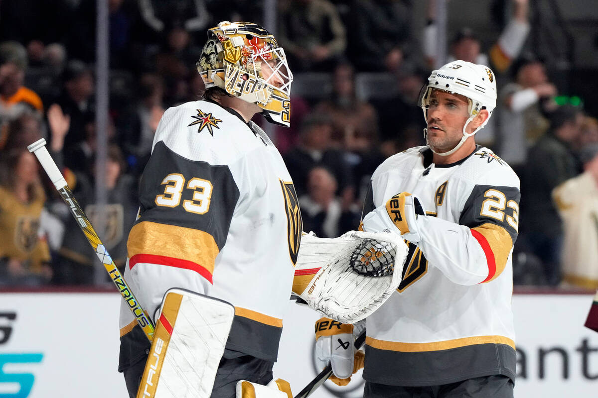 Vegas Golden Knights defenseman Alec Martinez (23) celebrates with goaltender Adin Hill after t ...
